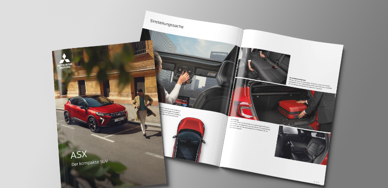 Die aufgeblätterte Broschüre des ASX liegt auf grauem Untergrund.