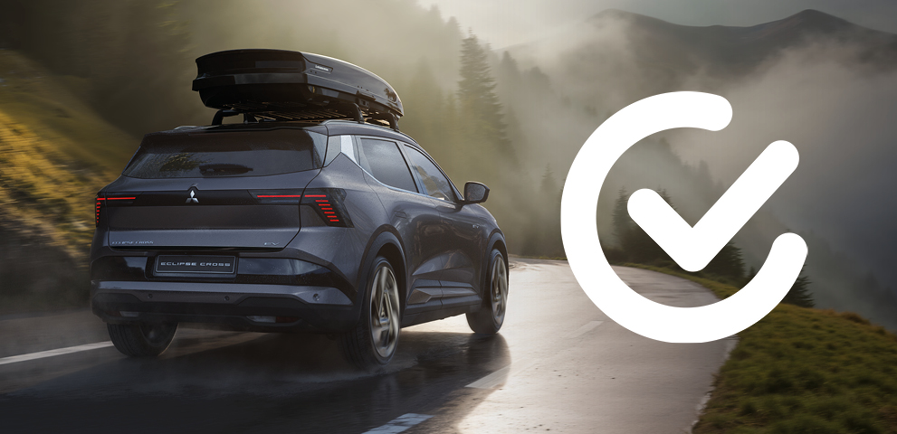 Mitsubishi Eclipse Cross f&auml;hrt auf einer kurvigen Bergstra&szlig;e bei Nebel und Sonnenlicht; rechts im Bild ist ein wei&szlig;es Haken-Icon abgebildet