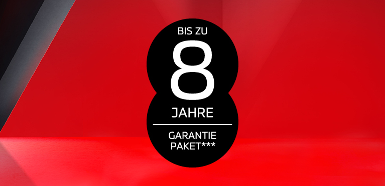 Schwarzer, runder Hinweisbutton auf rotem Hintergrund mit der Aufschrift &bdquo;Bis zu 8 Jahre Garantiepaket***"
